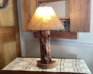 Lamp highly-figured with cherry base and parchment shade; 22” tall